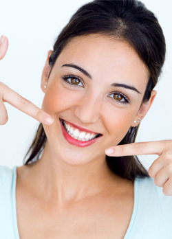 Woman pointing to beautiful smile