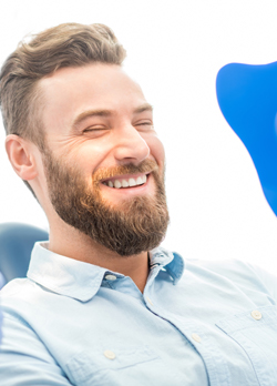 Man looking at smile in mirror