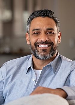 Man sitting on couch and smiling