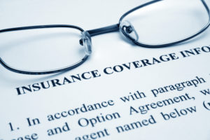 glasses on dental insurance paperwork