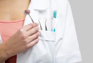 Dentist holding instruments and a toothbrush