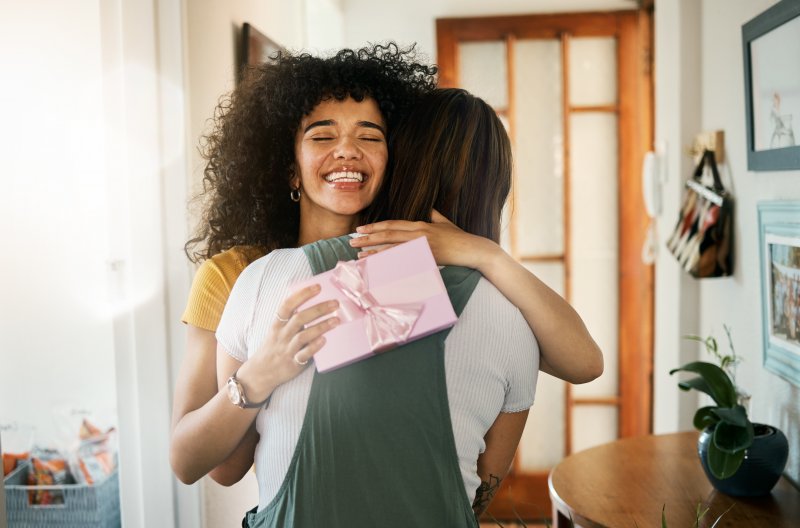 Friends exchanging smile-friendly gifts